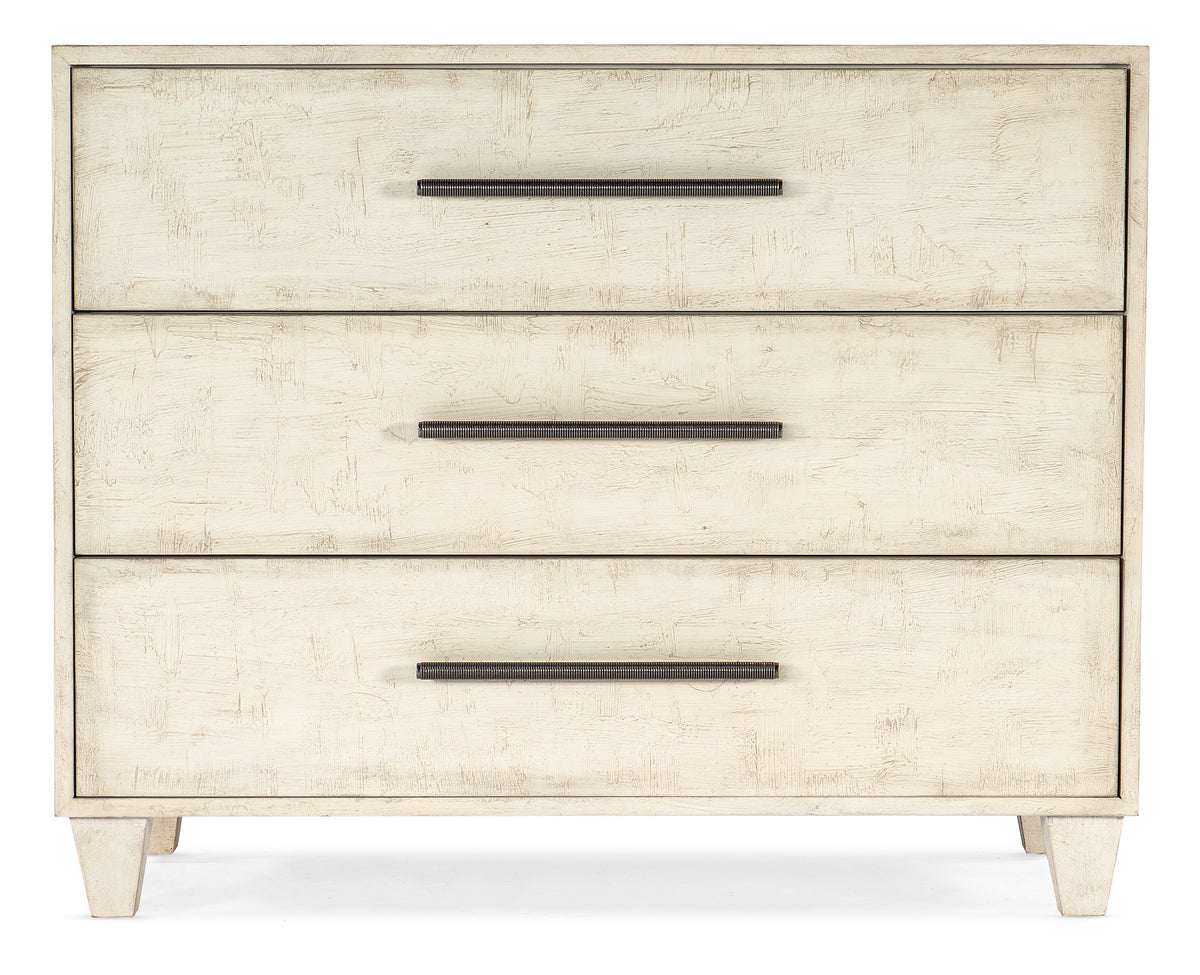 a white chest of drawers