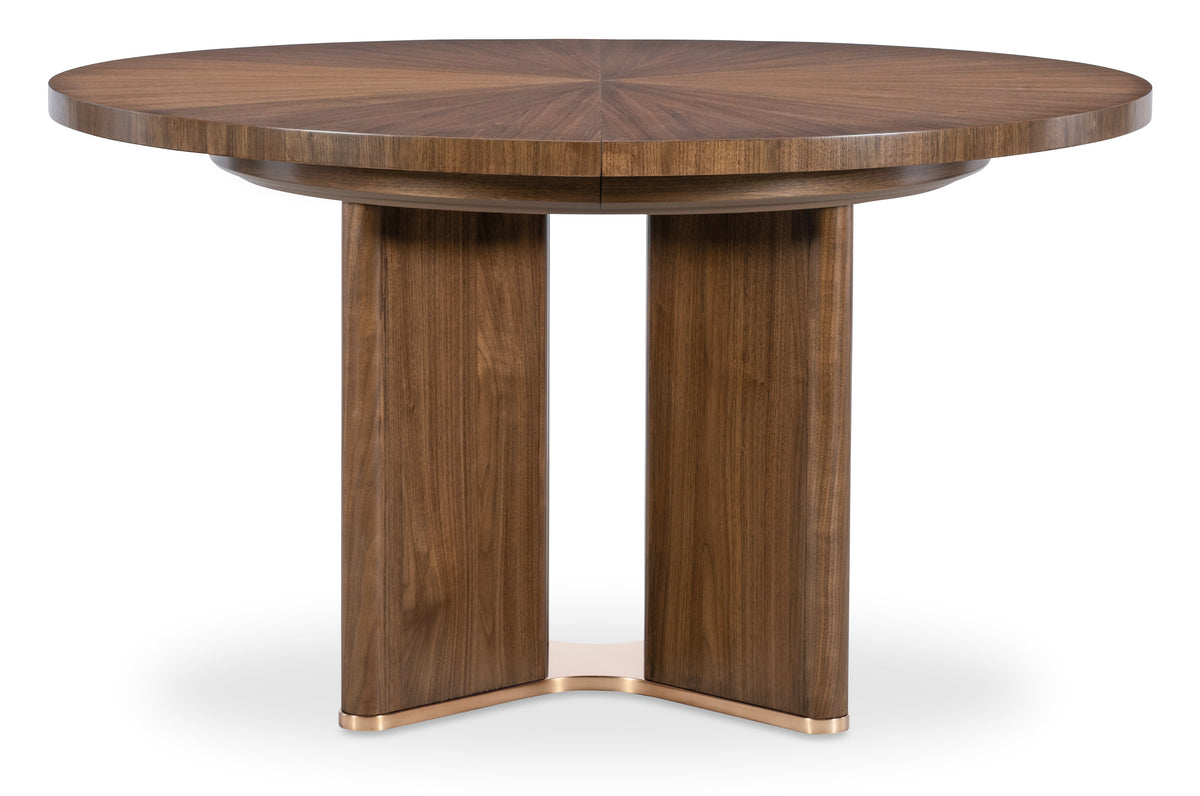 a round wooden table with a gold base
