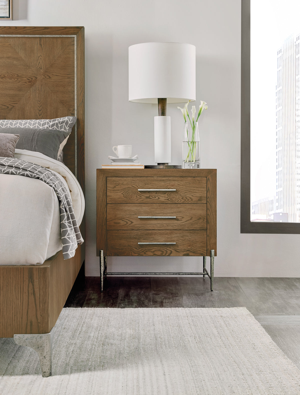 a nightstand next to a bed