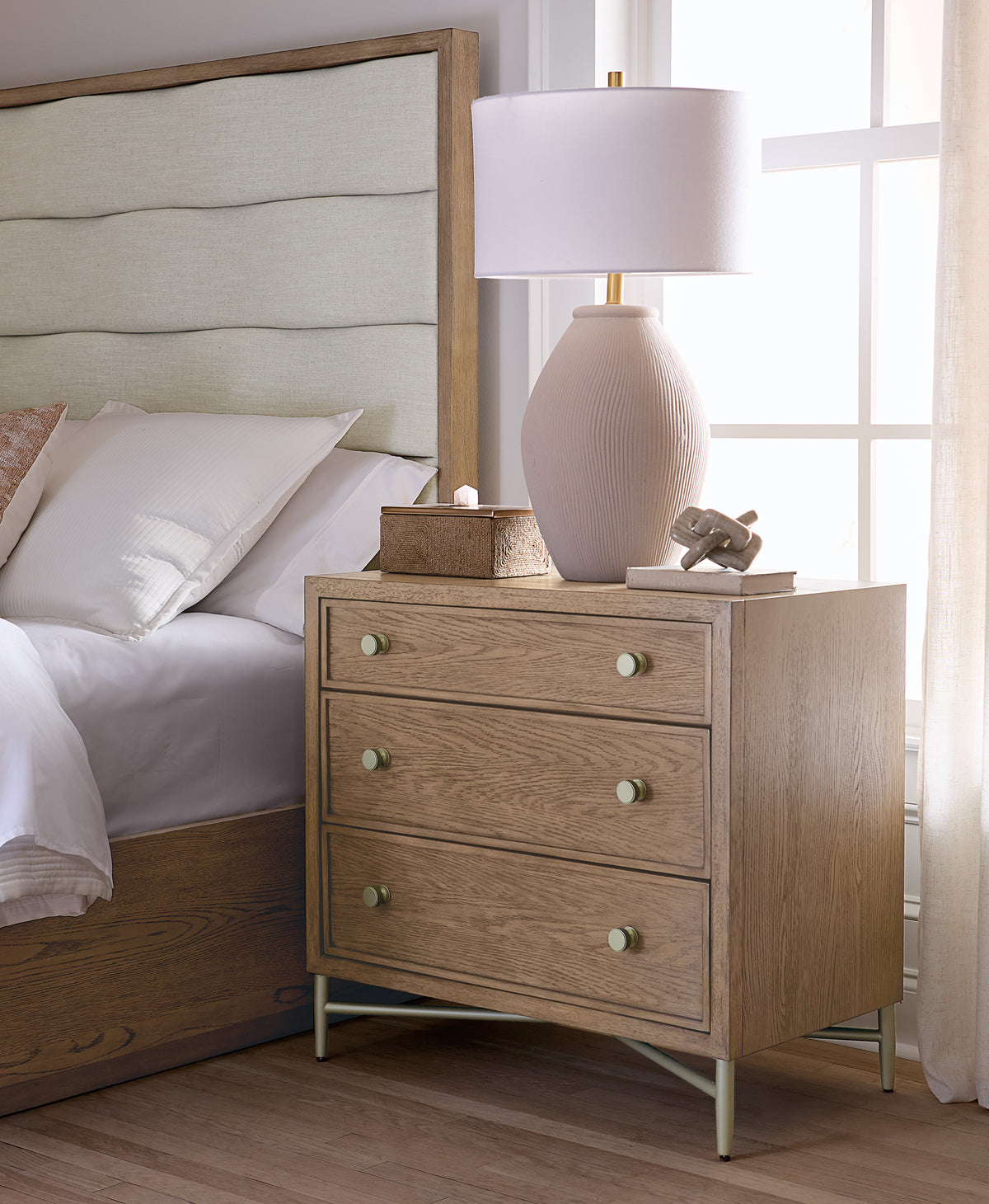a nightstand next to a bed