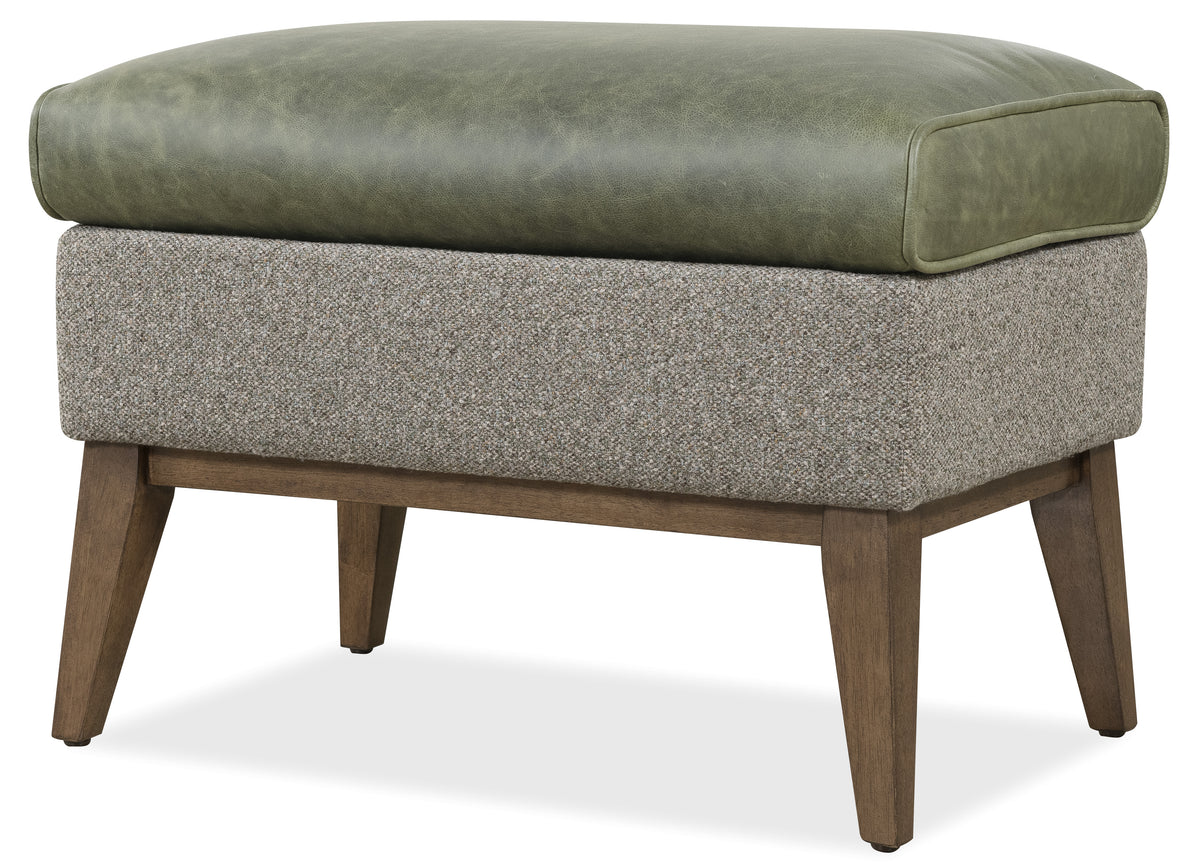 a green cushioned ottoman on a white background
