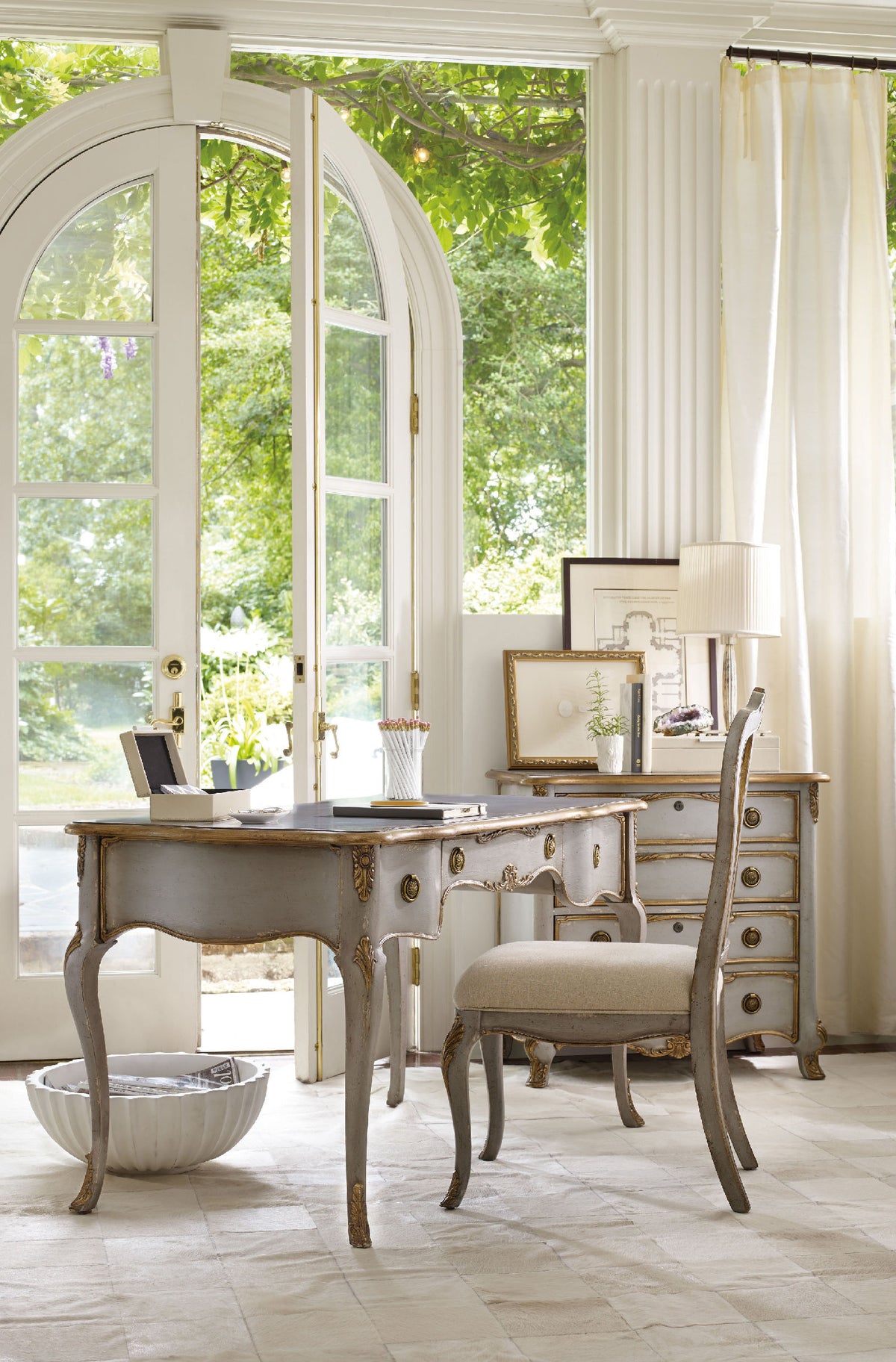 a desk and chair in a room with windows