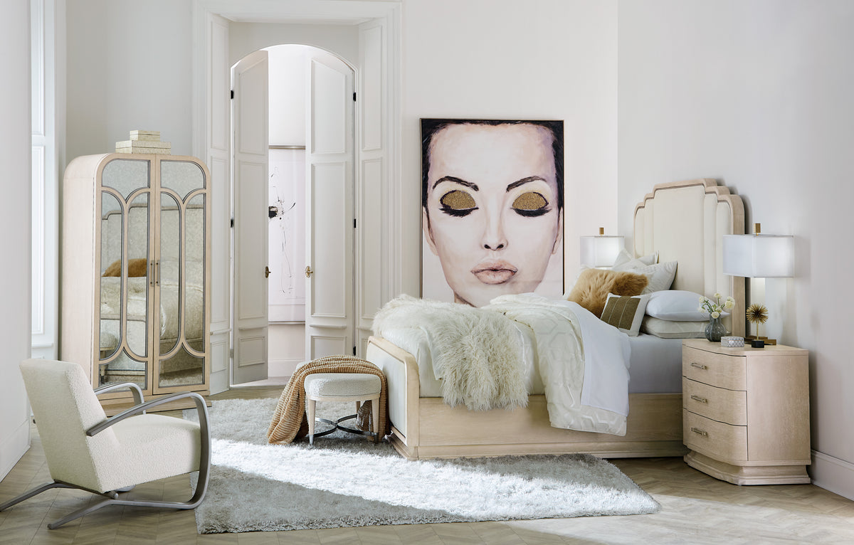 a bedroom with a large painting of a woman's face