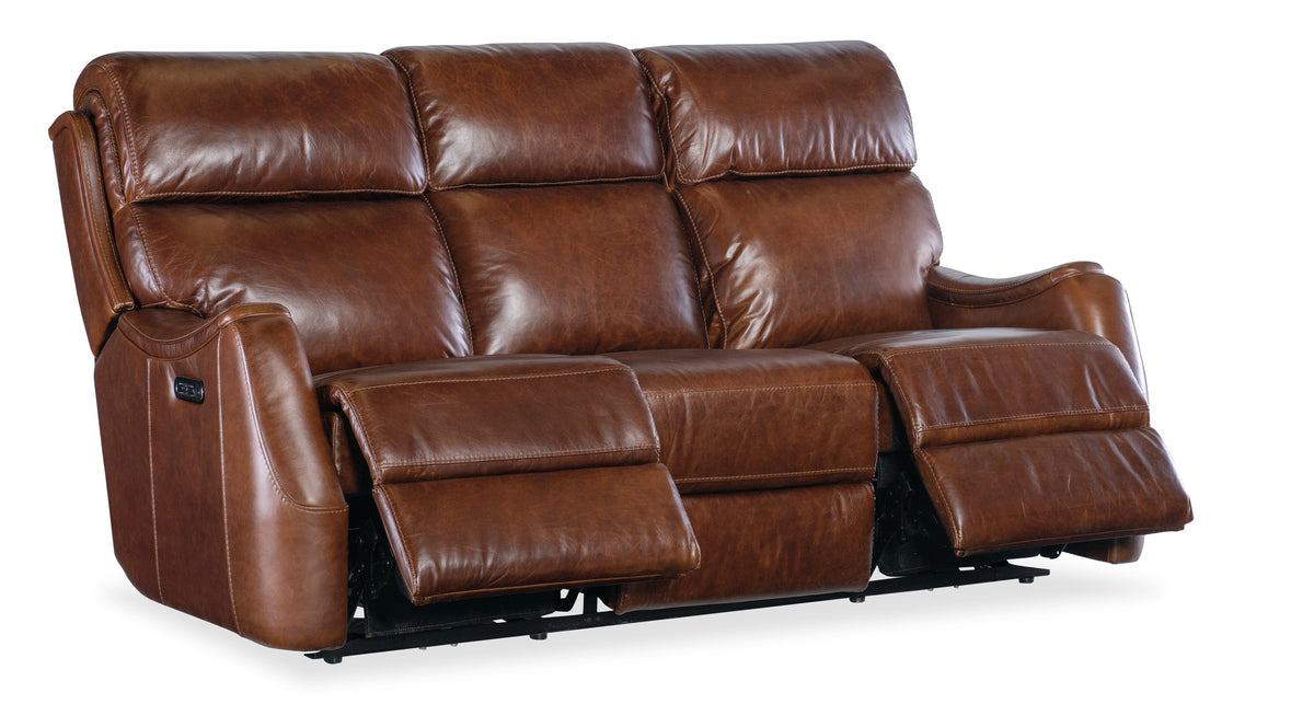 a brown leather couch with two recliners