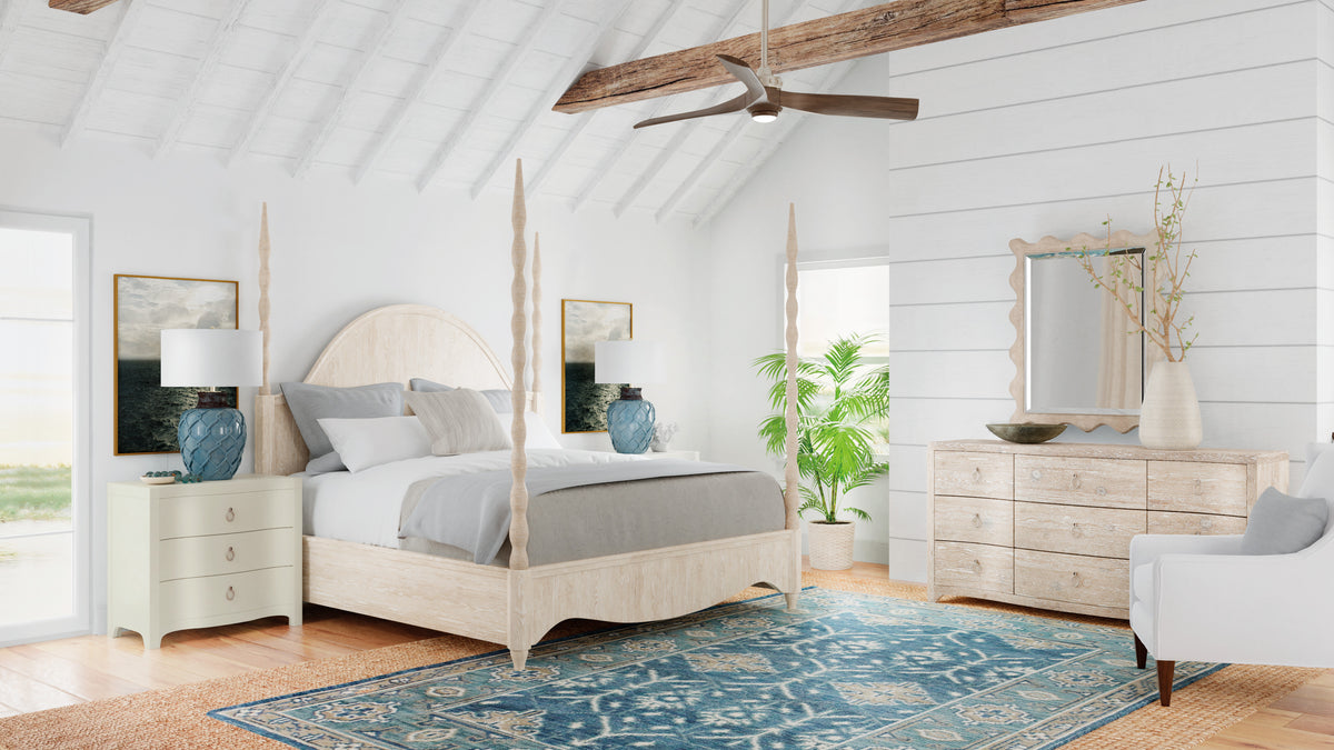 a bedroom with a blue rug and a white bed
