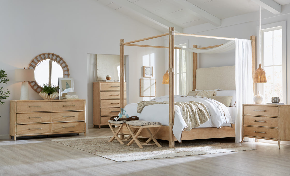 a bedroom with a canopy bed and dresser
