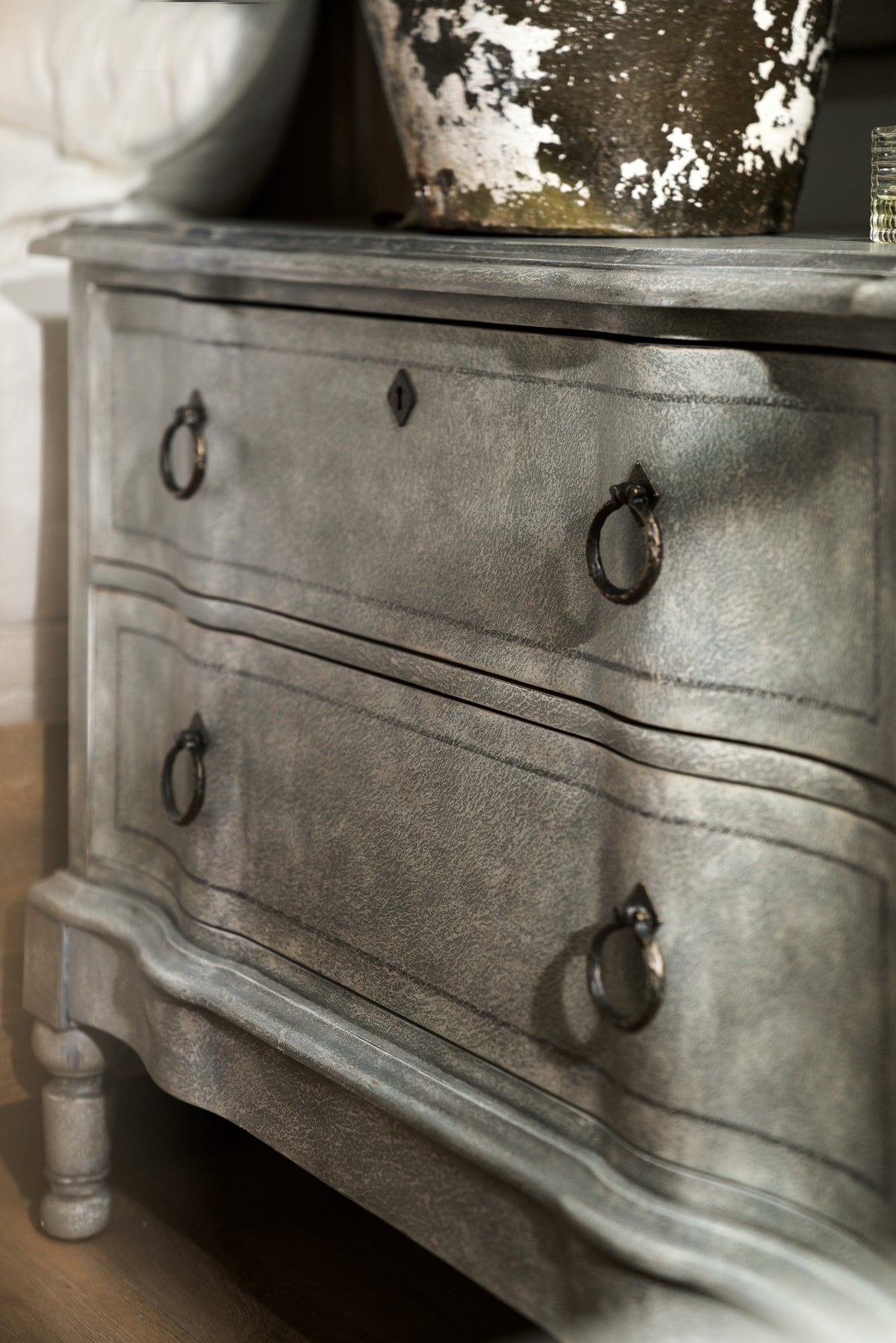 a grey dresser with handles