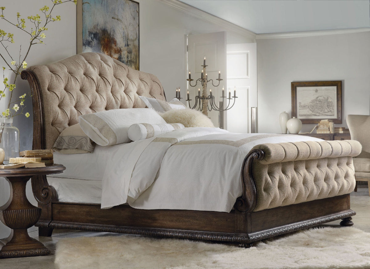 a bed with a white bedding and a chandelier