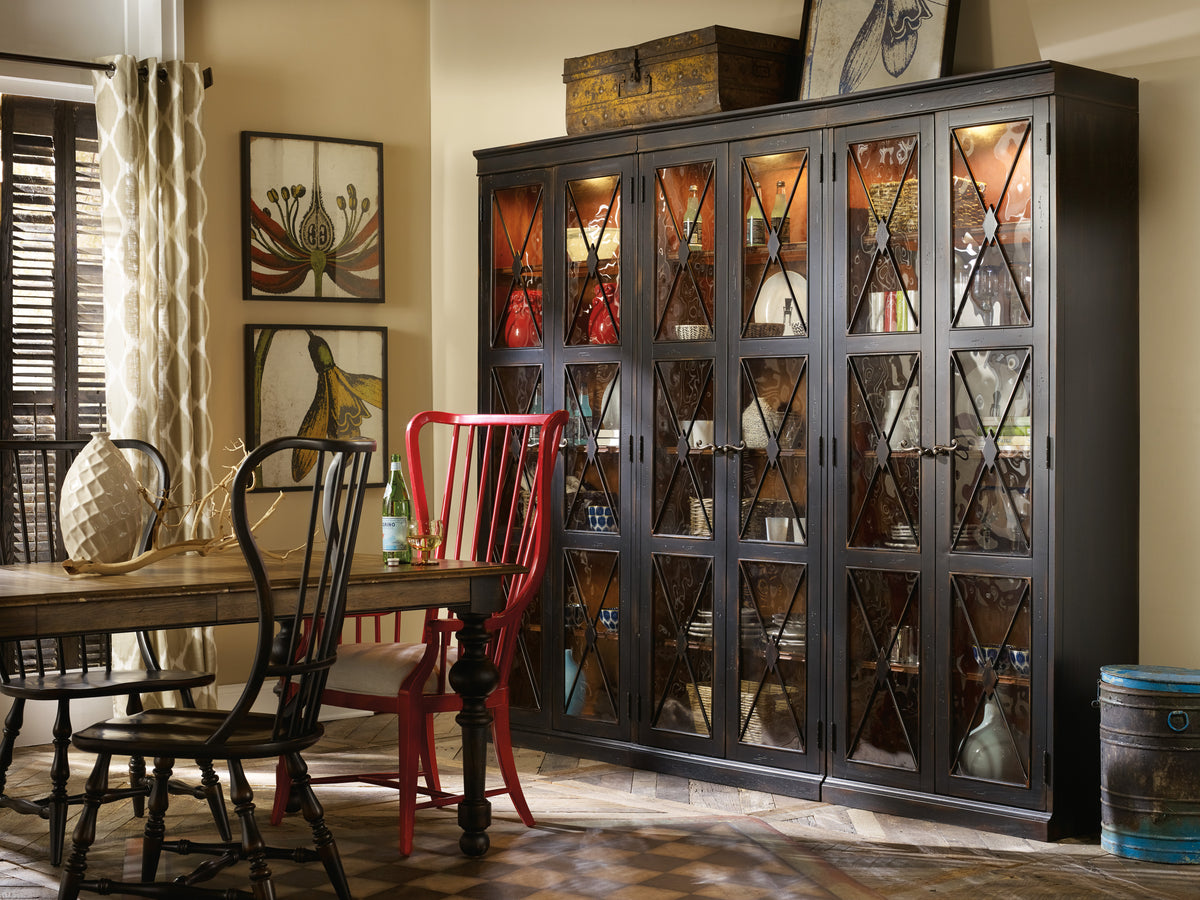 a dining room with a cabinet and chairs