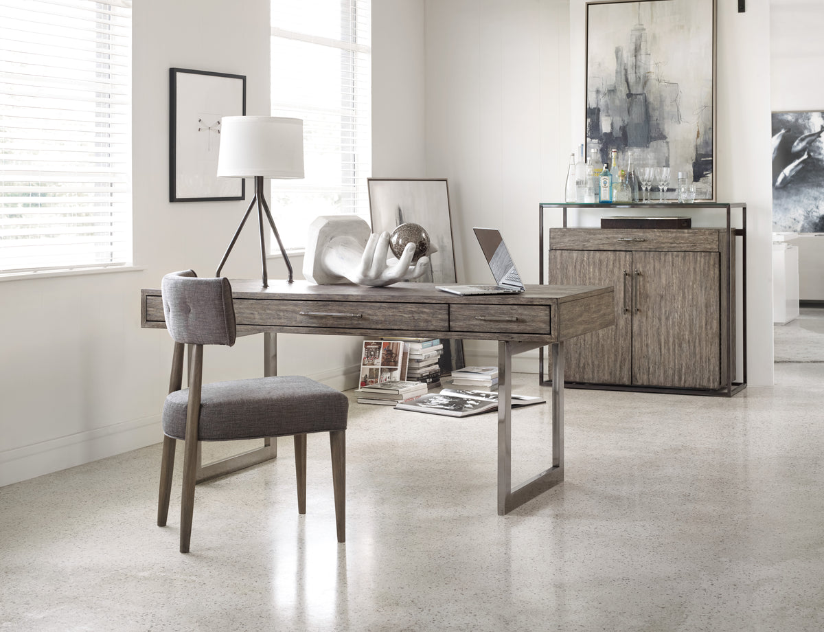 a desk with a chair and a lamp in a room