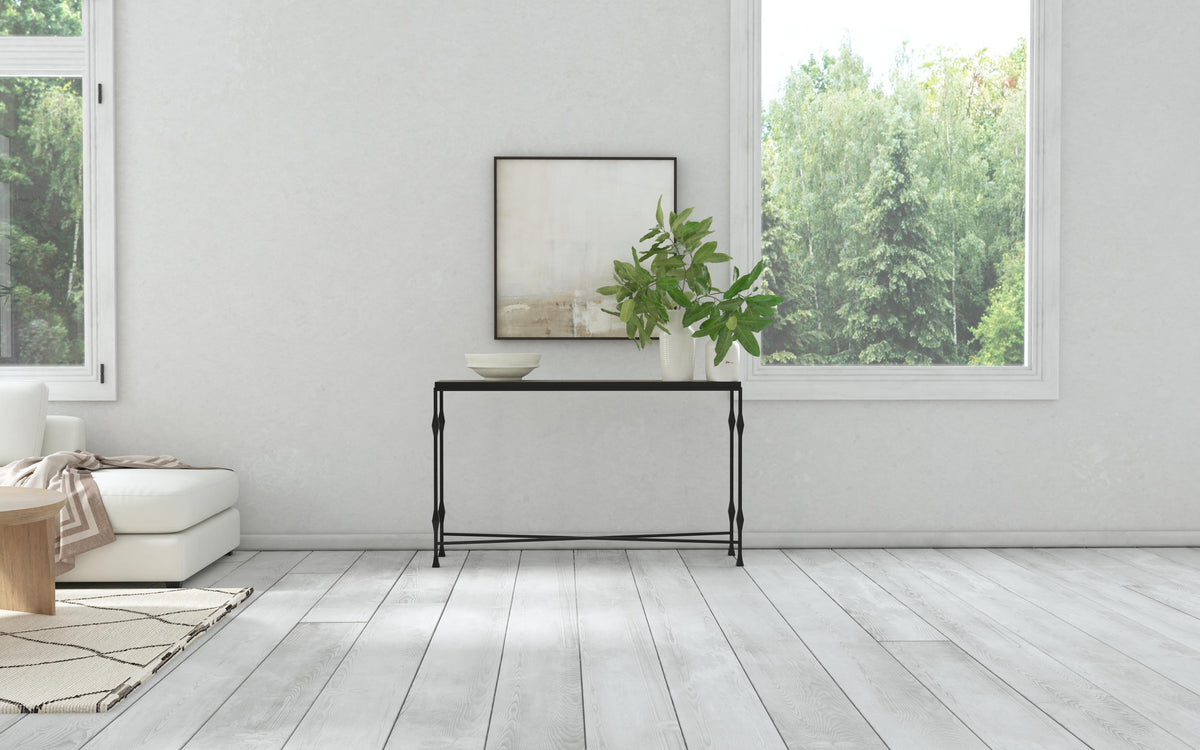 a white room with a table and plant