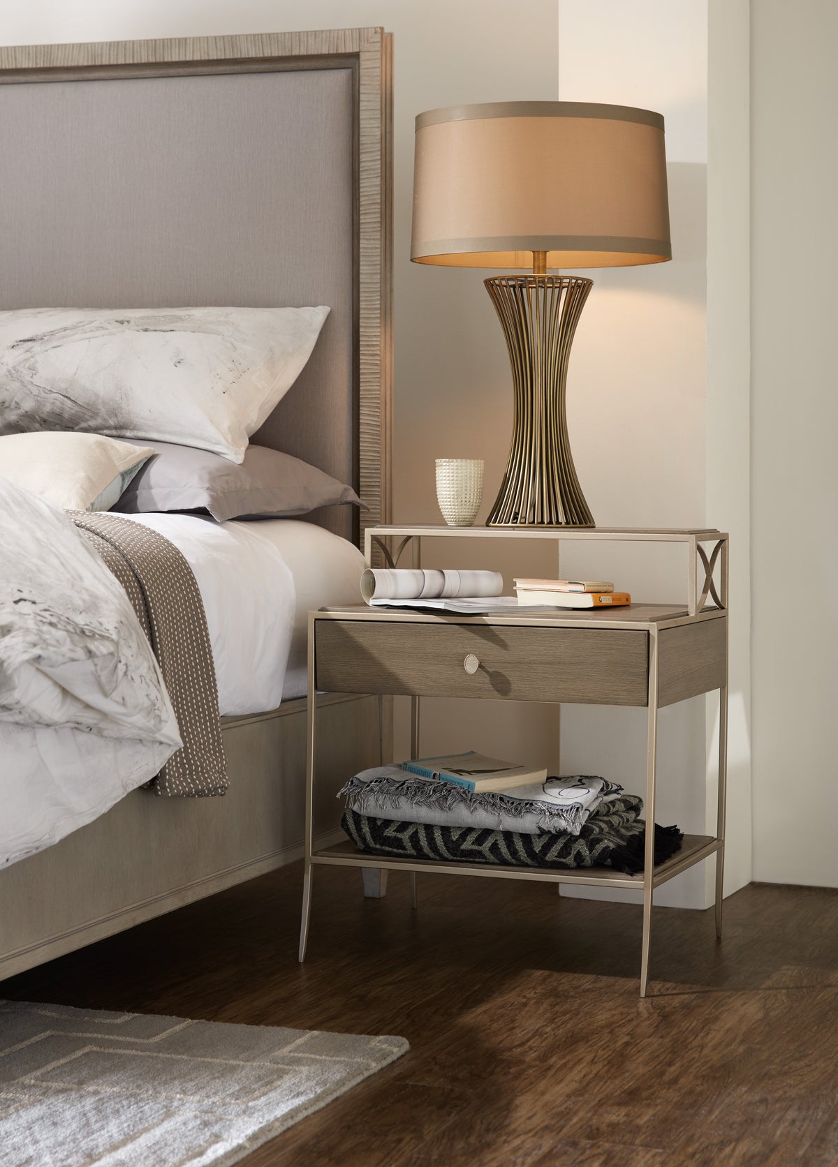 a nightstand next to a bed