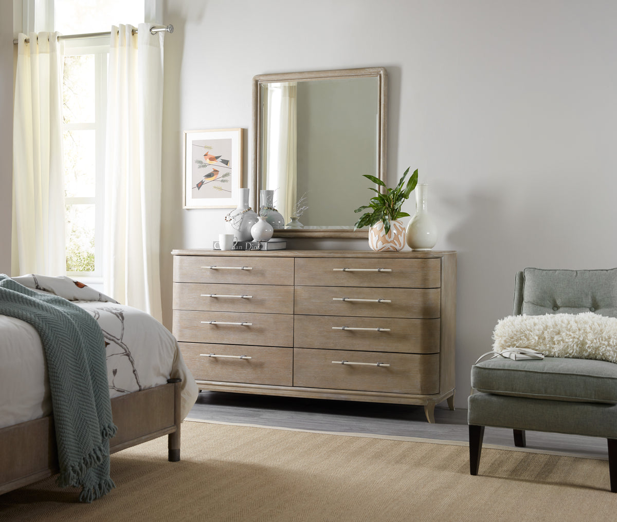 a bedroom with a dresser and chair