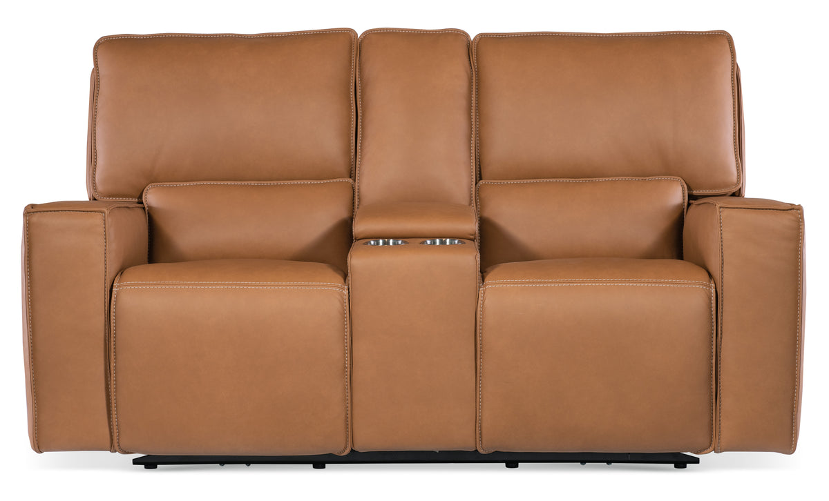 a brown leather couch with two armrests