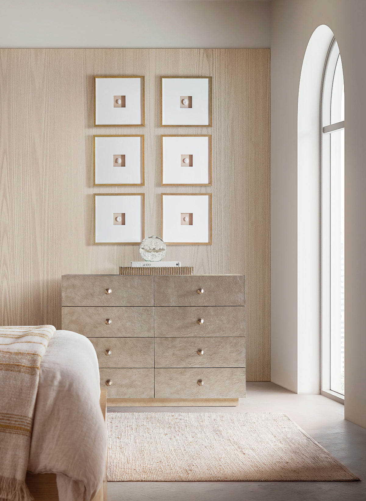 a bedroom with a dresser and a bed