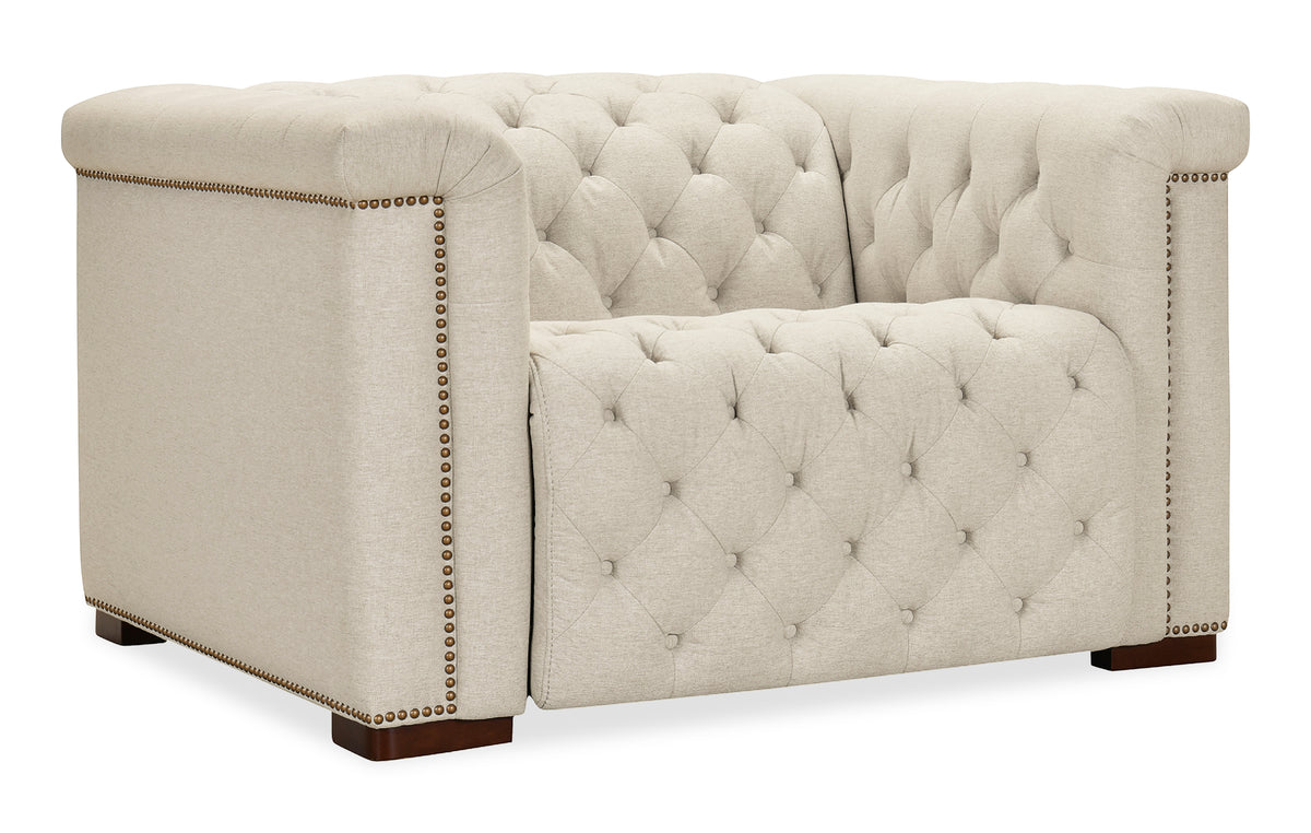 a white couch with gold studs