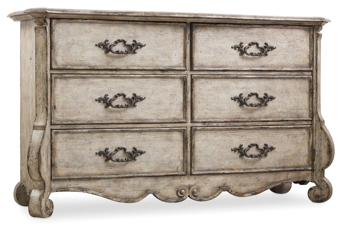 a white dresser with black handles