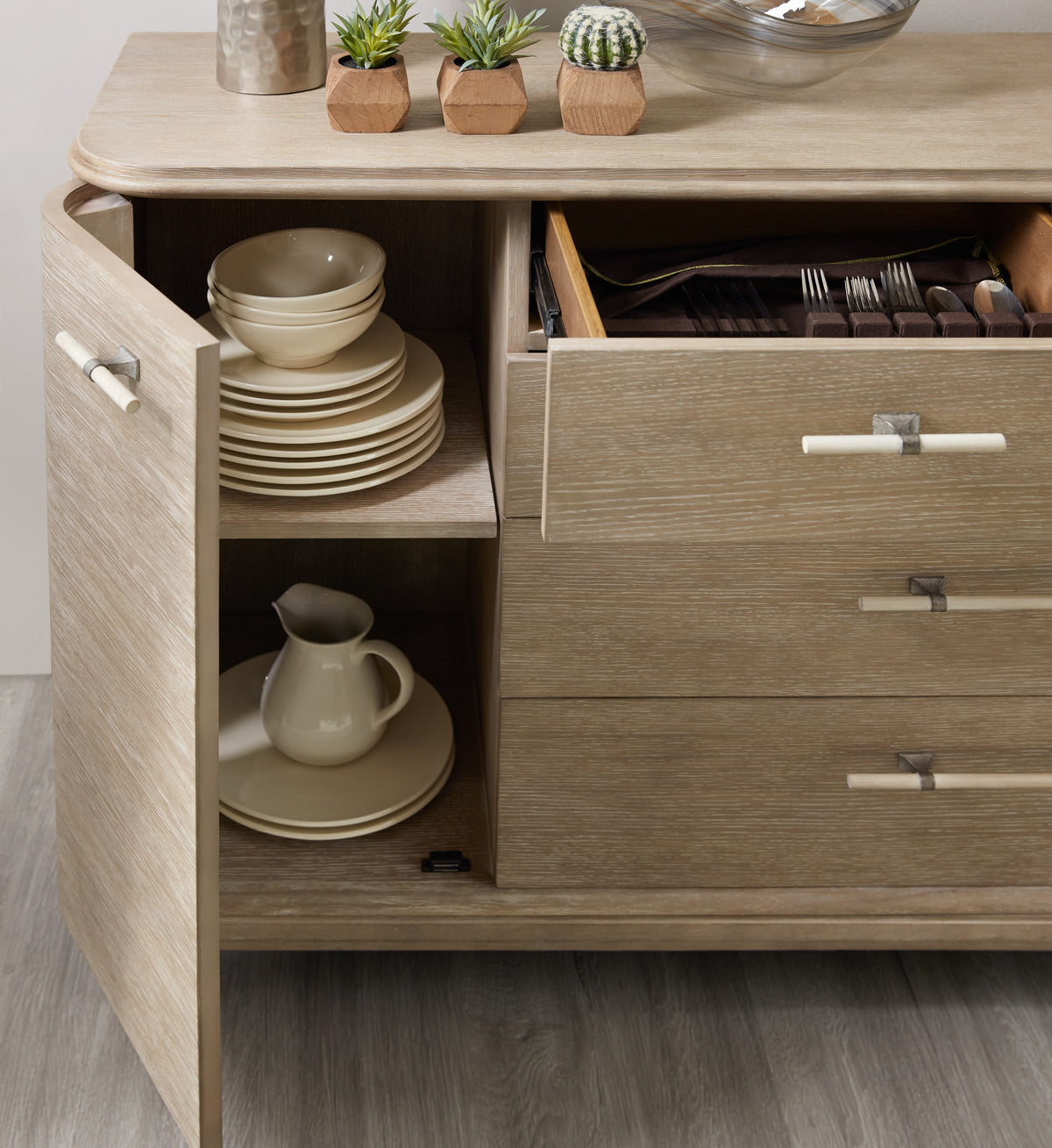 a cabinet with a drawer full of plates and dishes