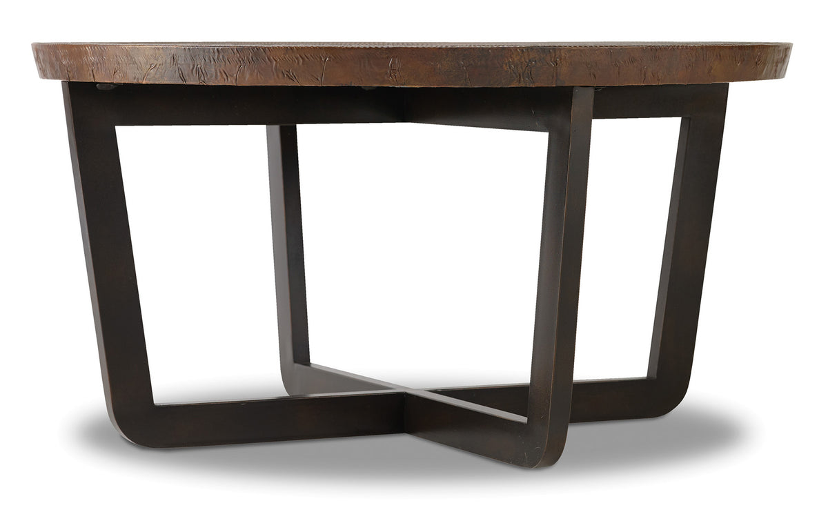 a round wooden table with a cross leg