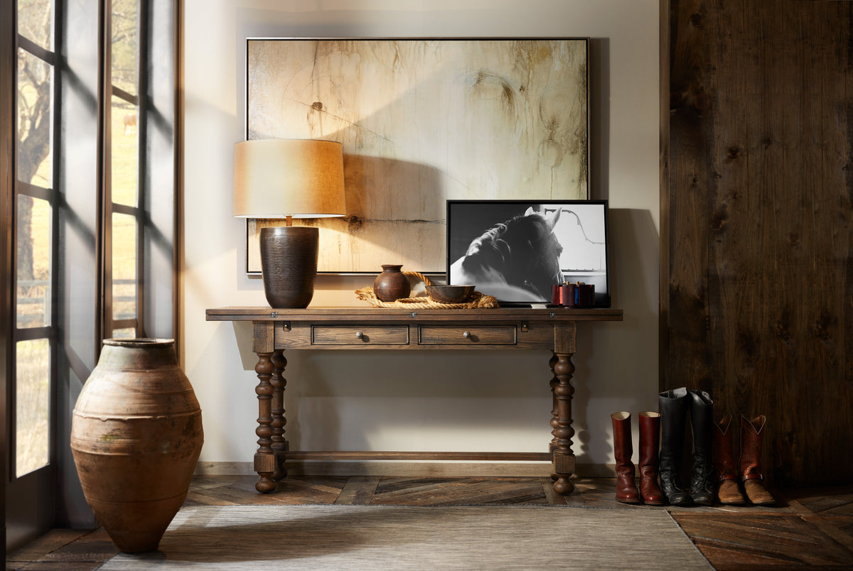 a table with a lamp and a picture on it