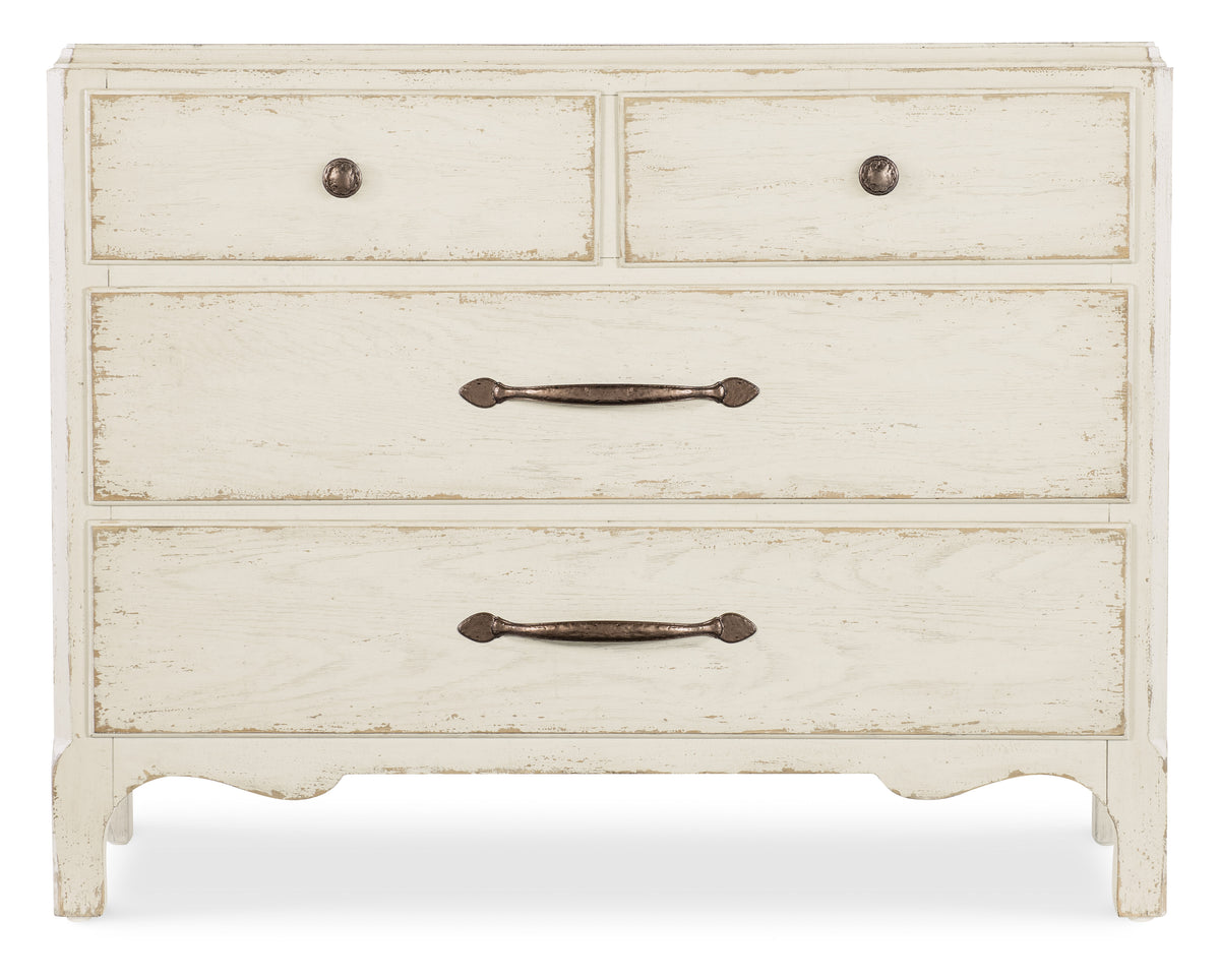 a white dresser with metal handles