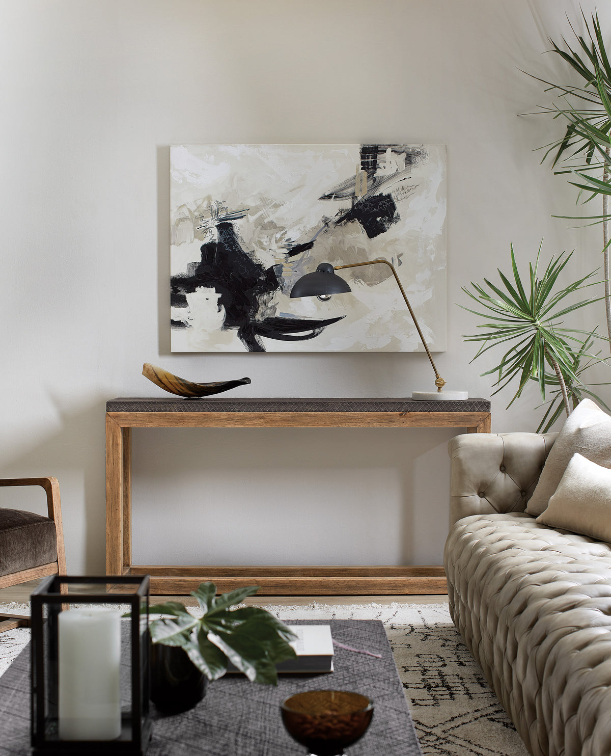 a room with a couch and a painting on the wall