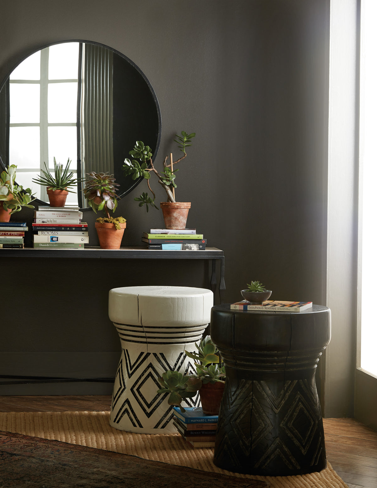 a round mirror with plants in it
