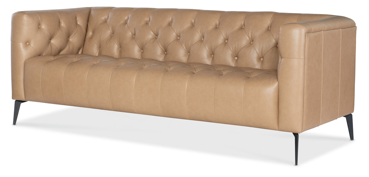 a brown leather couch with white base
