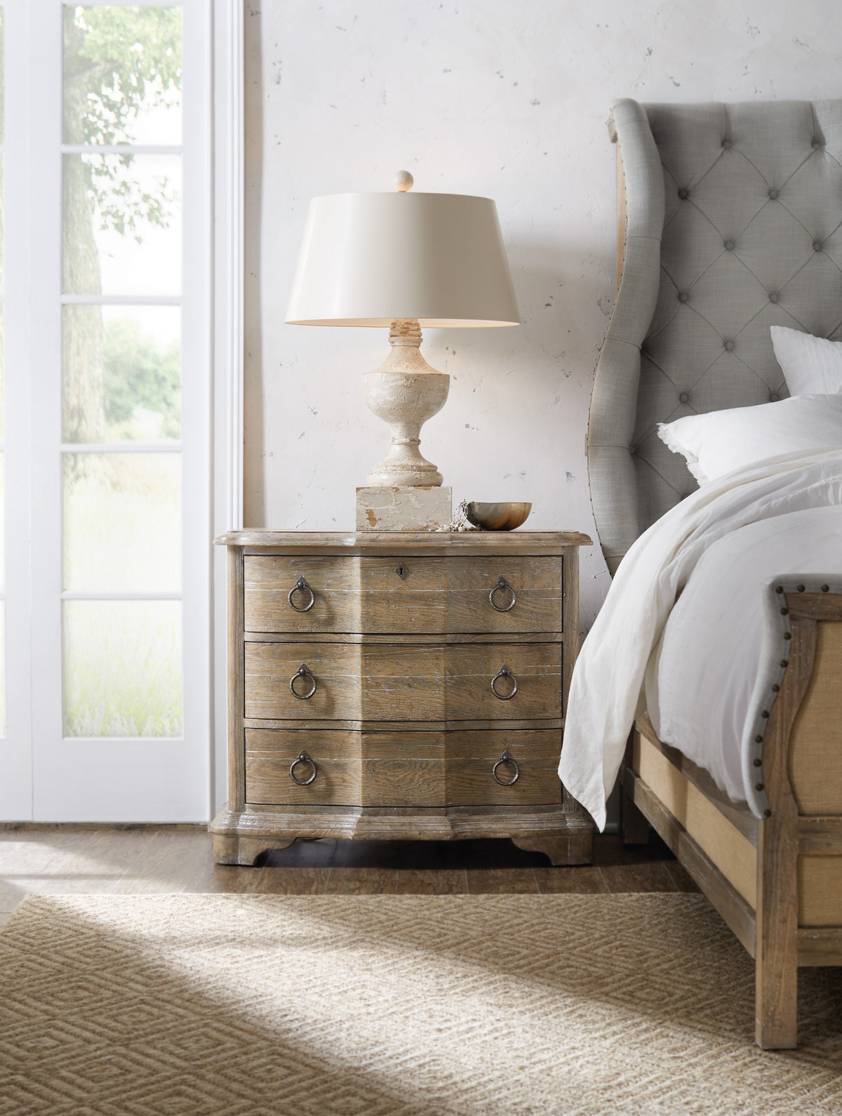 a nightstand next to a bed