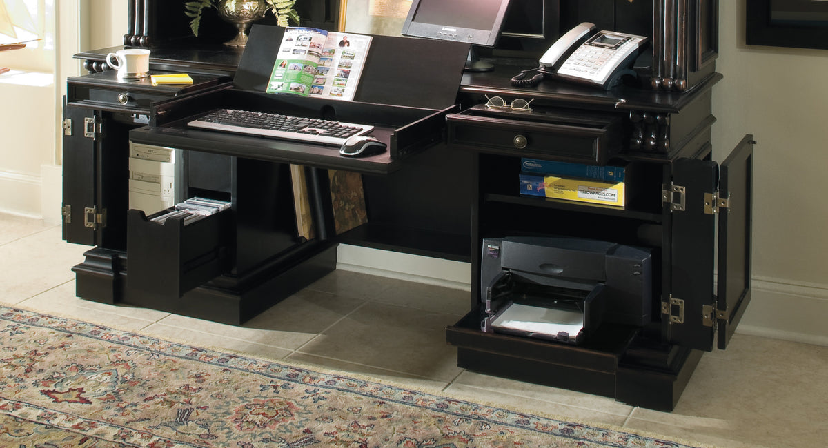 a desk with a keyboard and a printer