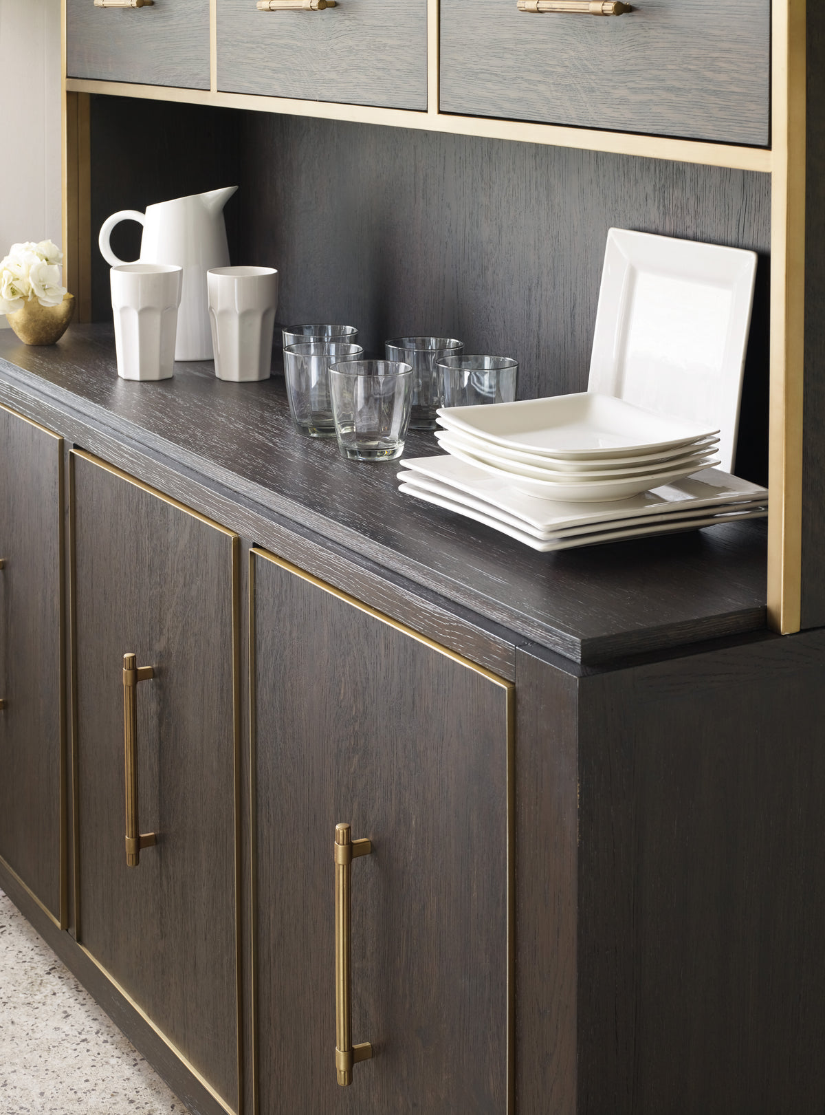 a black counter top with white plates and glasses
