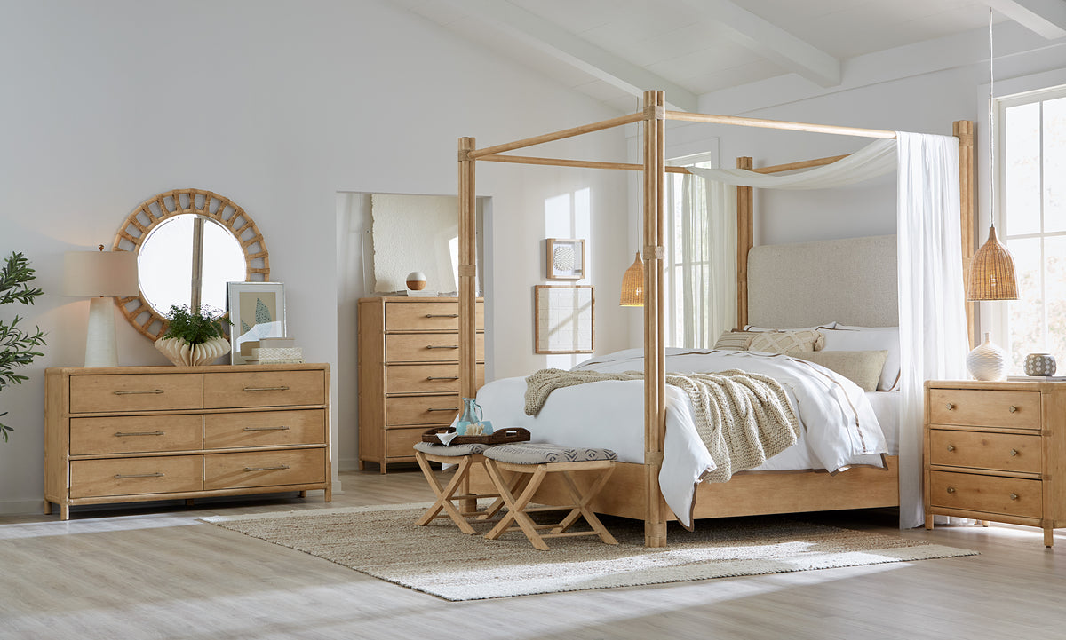 a bedroom with a four poster bed and a dresser
