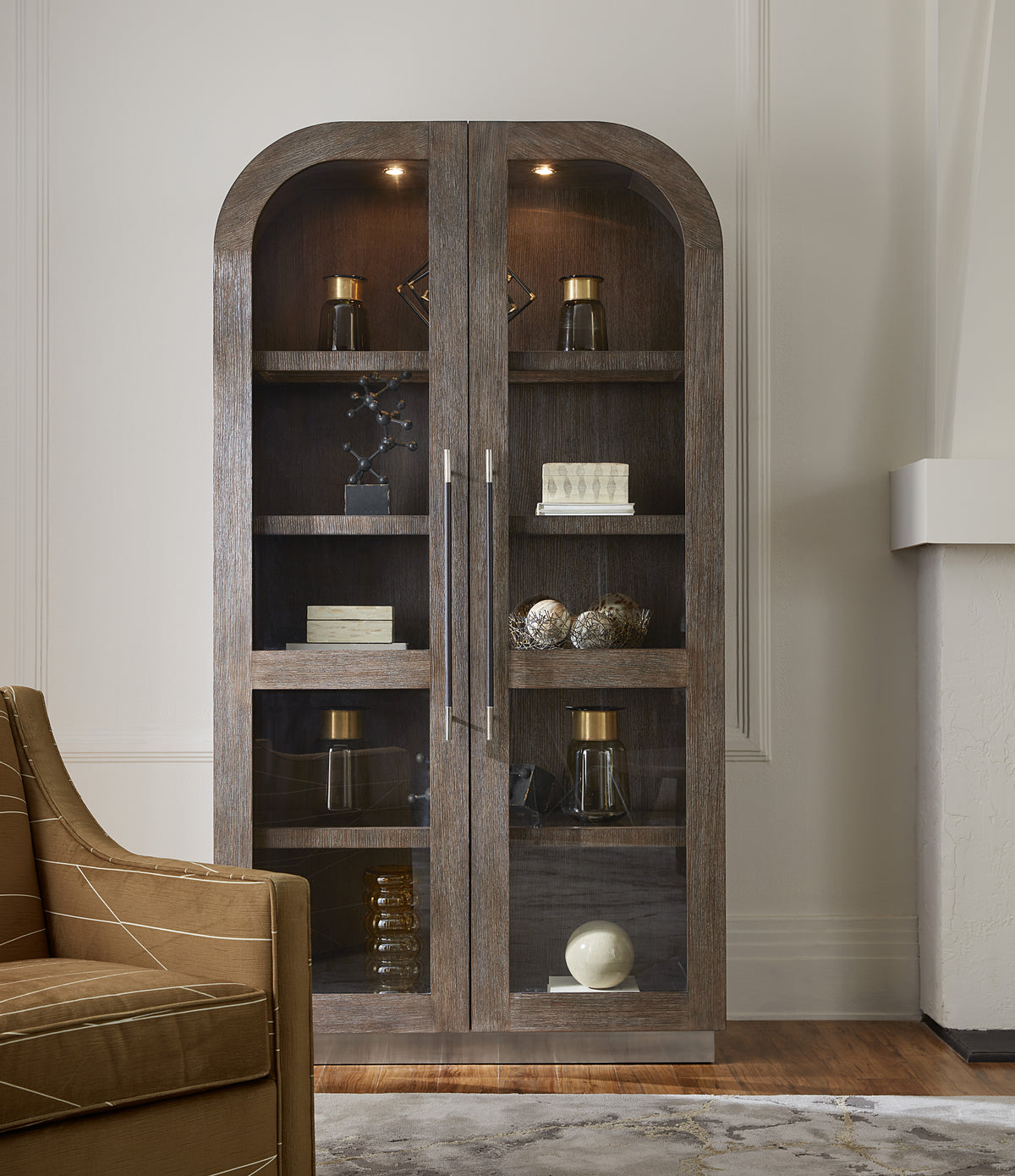 a glass cabinet with shelves and objects on it
