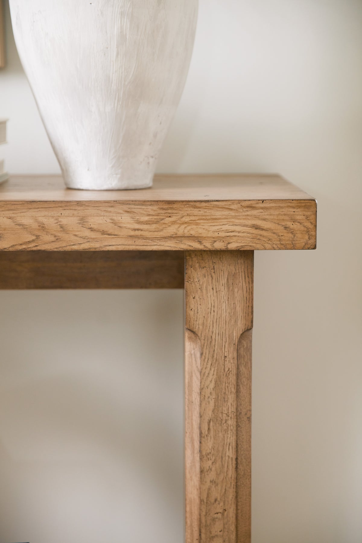 a white pot on a wooden table