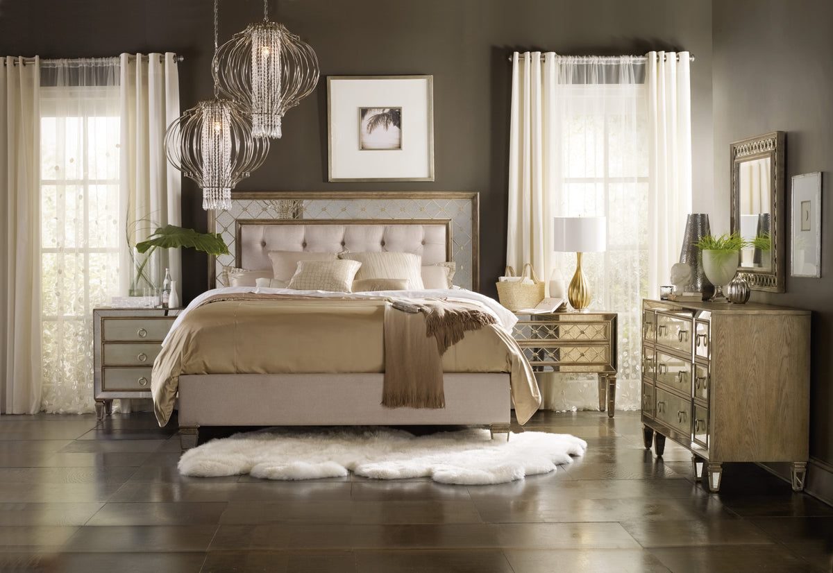 a bedroom with a bed and chandeliers