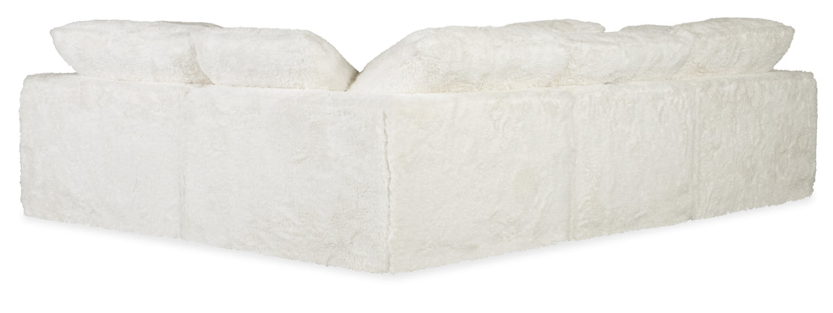 a white fluffy chair with two pillows